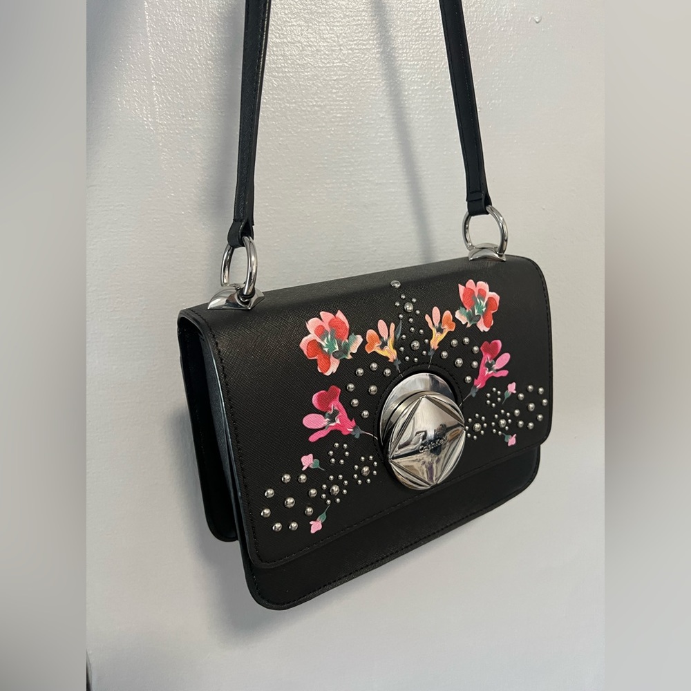 It is a Calvin Klein cross body bag in multi shade/black. It is new with tags.